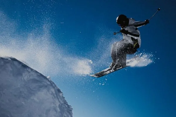 female skier aerial jump snow
